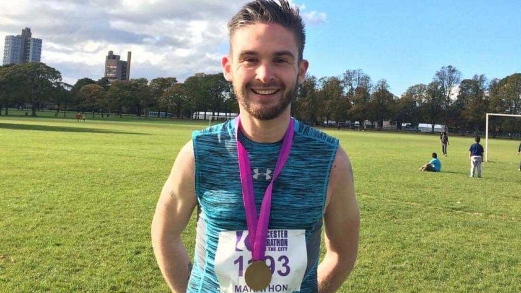 Chris, Investigations Officer in the Major Crime Team at Surrey Police, with a medal around his neck having completed the Leicester Marathon in the past